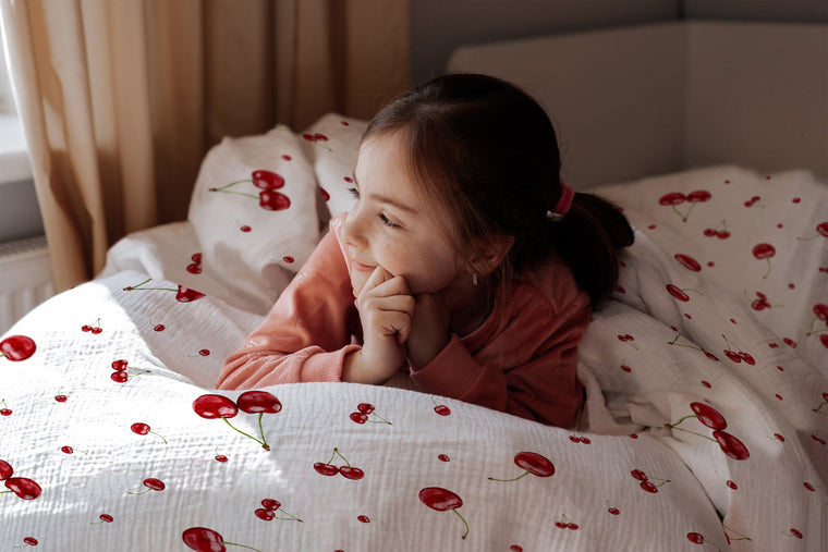 Mädchen im Bett mit fröhlicher Kirschen-Bettwäsche „Kirschen"